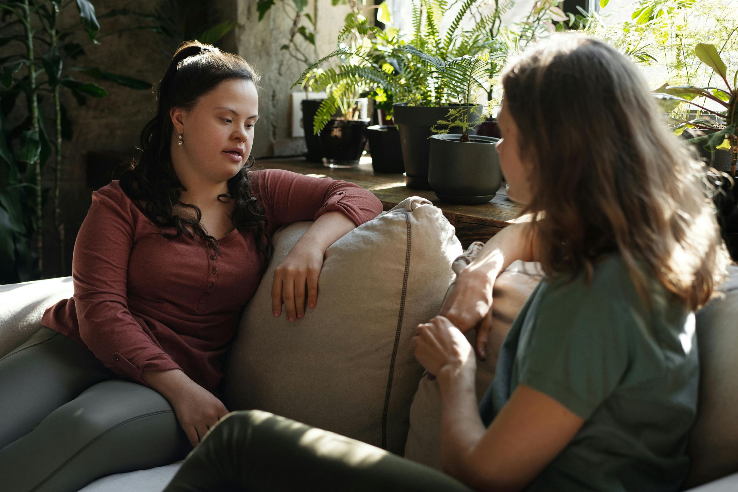 A young girl is speaking with a woman